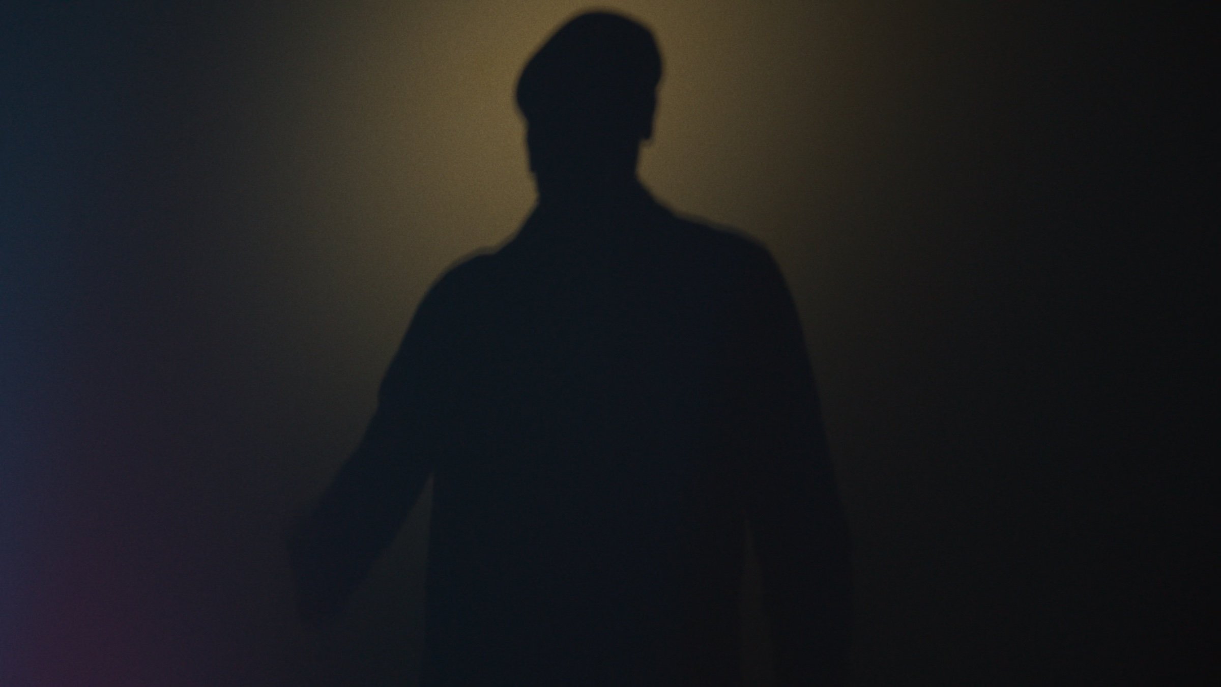 A silhouetted figure in haze.